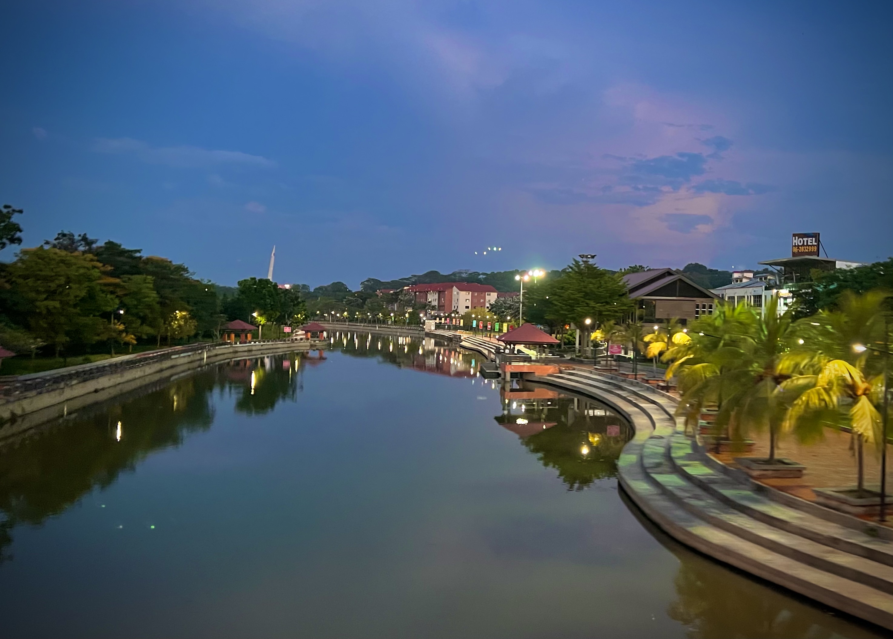 Melaka River at dusk in March 2023, with riverside lights reflected in the water